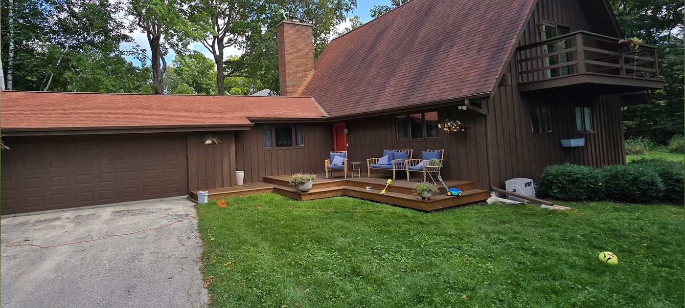 After: cedar A-frame home repainted a rich brown